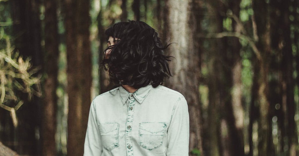Image of woman with black hair in the woods
