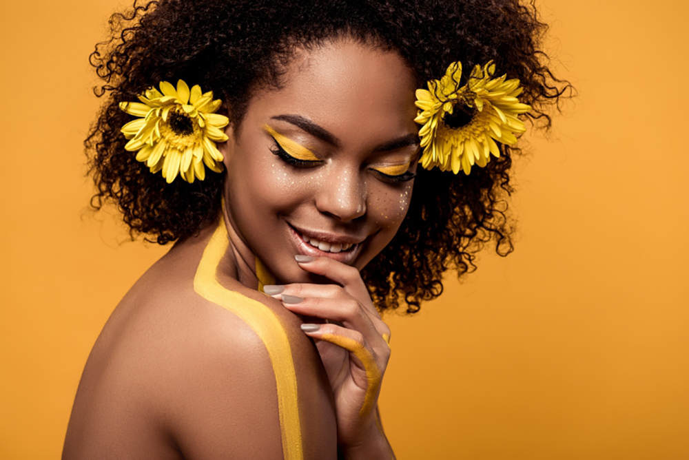 Image of black woman with sunflowers in her hair