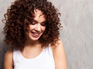woman posing with curly brown hair