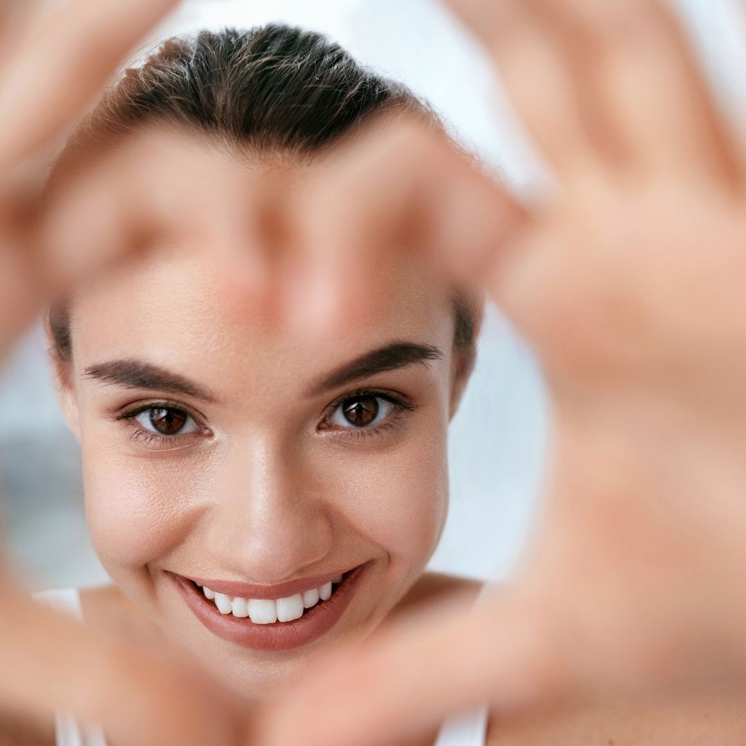 woman making a heart with hands