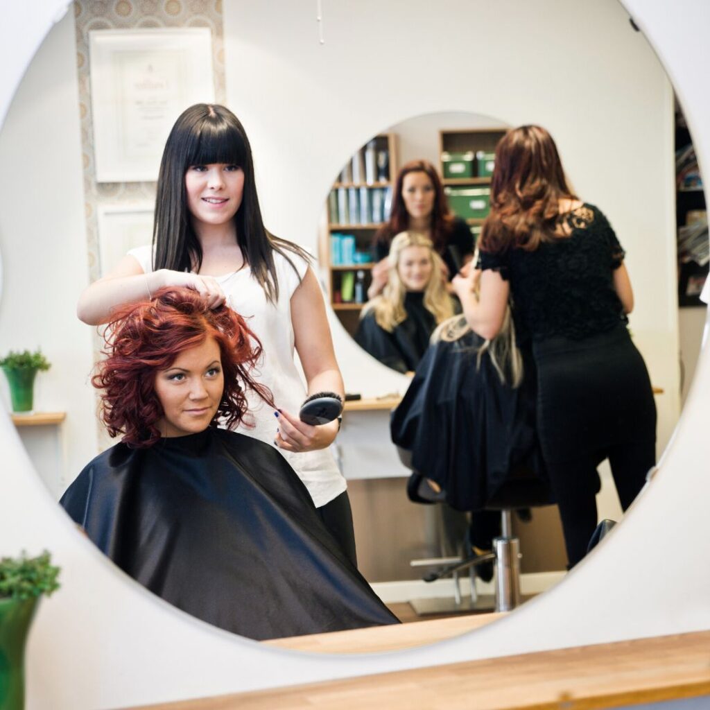 stylist brushing client's hair