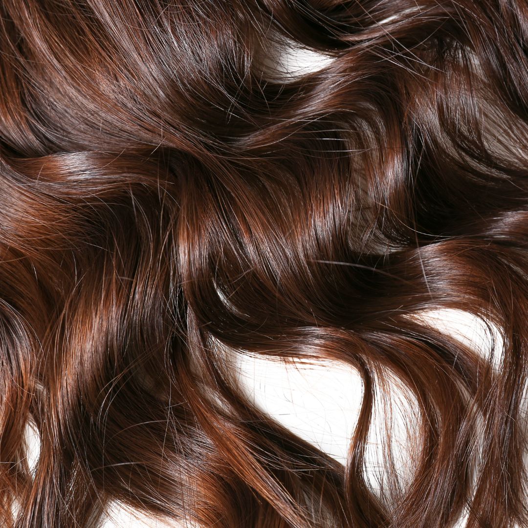 Long, flowing brunette hair.